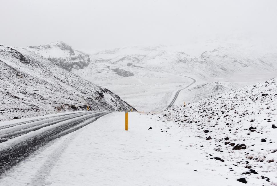 Free Image of Snowy Road With Yellow Post 