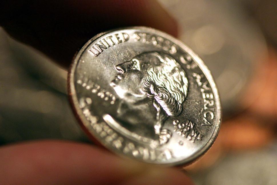 Download Free Stock Photo of Fingers holding a US quarter coin 