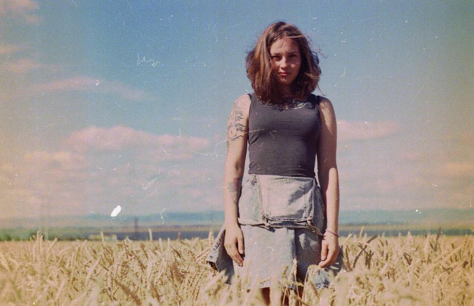 Free Image of Woman Standing in a Wheat Field 