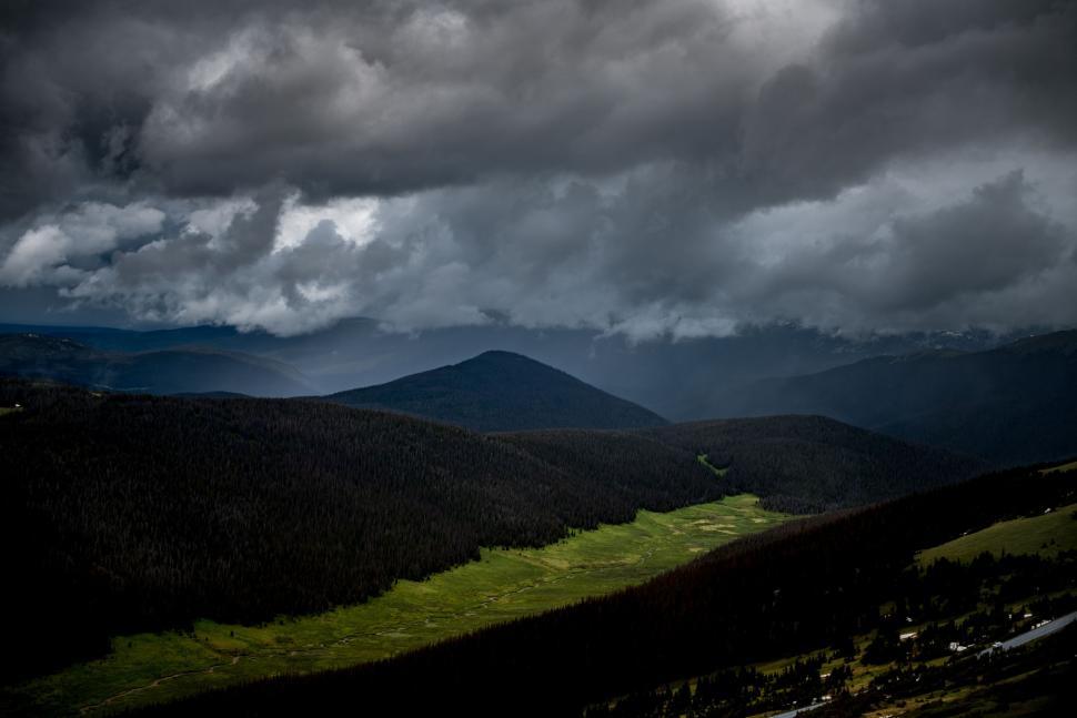 Free Image of Dark and Stormy Sky Over a Mountain Range 