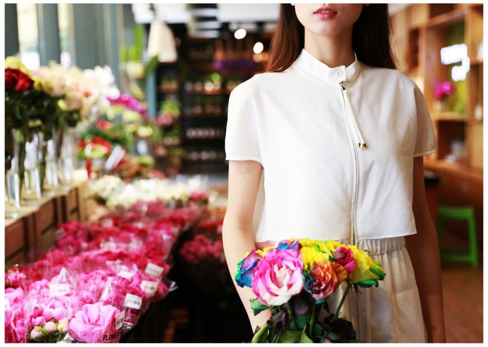 Free Image of Woman Holding Bouquet of Flowers in Flower Shop 