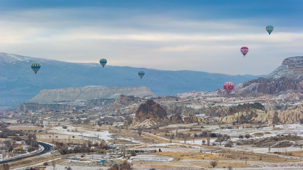 Free Image of Hot Air Balloons Flying Over Valley 