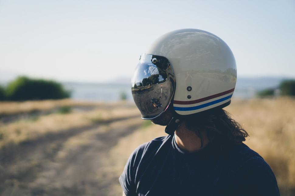 Free Image of Person Wearing Motorcycle Helmet on Dirt Road 