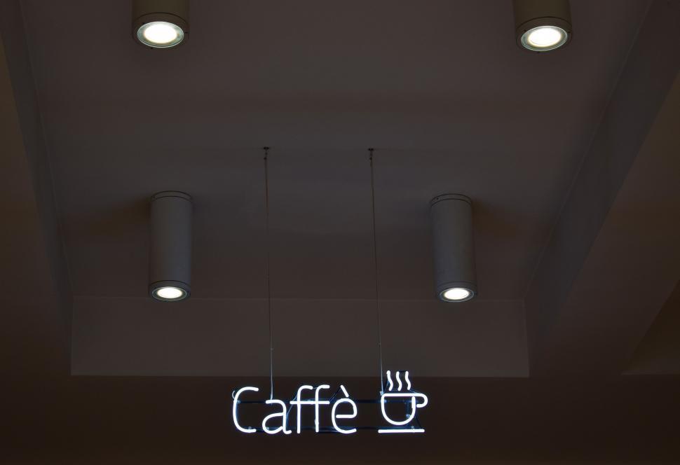 Free Image of Coffee Shop Sign With Three Lights Above It 