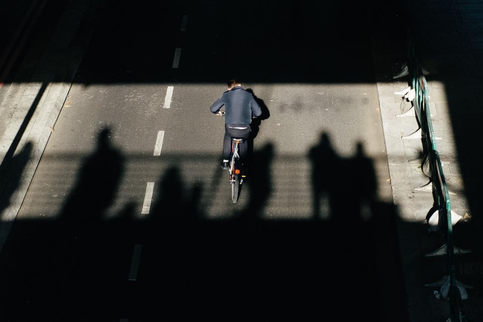 Free Image of Person Riding Bike Down City Street 