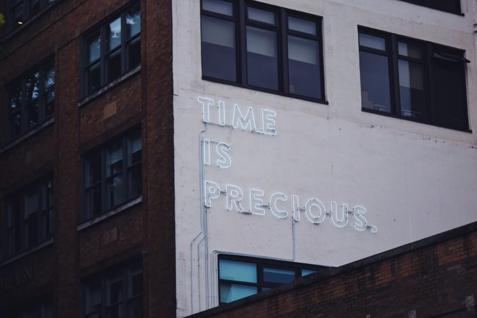 Free Image of White Building With Time Is Precious Sign 