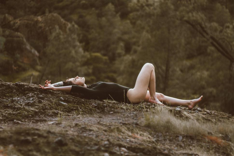Free Image of Woman Laying on the Ground 