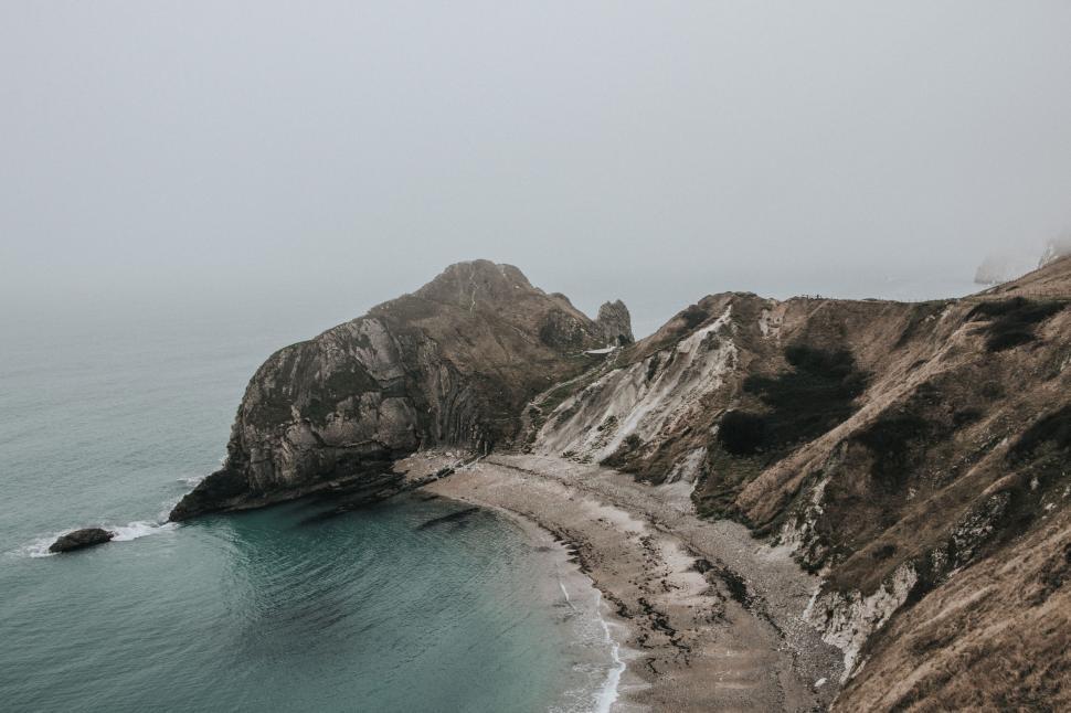 Free Image of Aerial View of Rocky Coastline in the Fog 