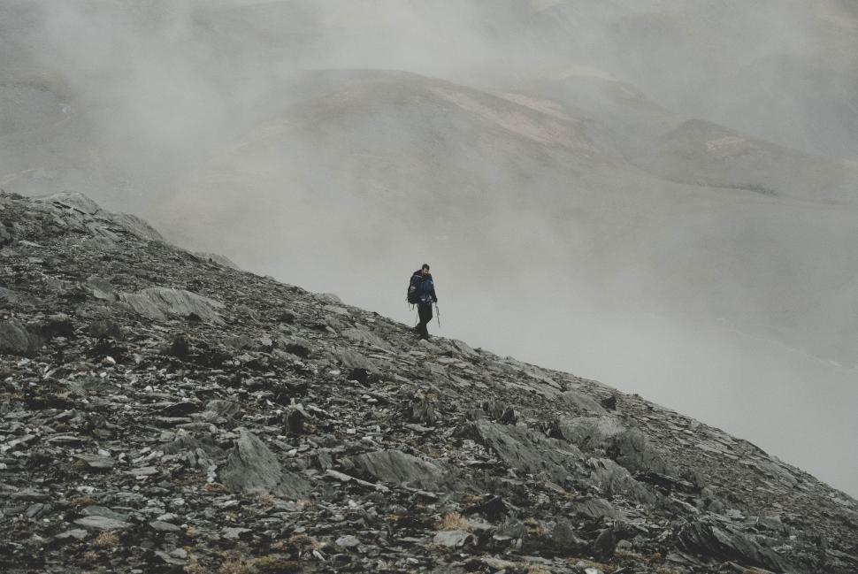 Free Image of Man Standing on Top of Rocky Mountain 
