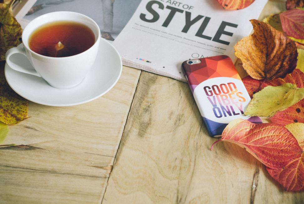 Free Image of A Cup of Tea and a Book on a Table 