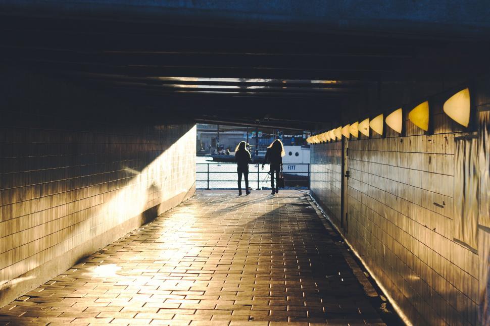 Free Image of People Standing in a Tunnel 