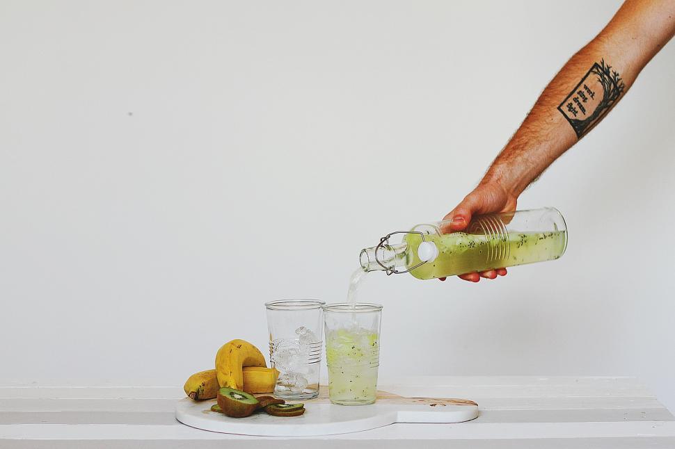 Free Image of Person Pouring Drink Into Glass 