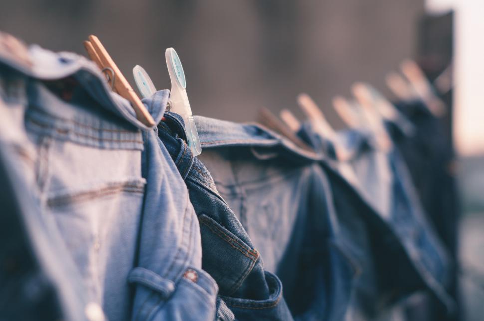 Free Image of Row of Jeans Hanging on Clothes Line 