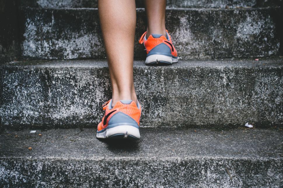 Free Image of Person Walking Up Stairs With Orange Shoes 