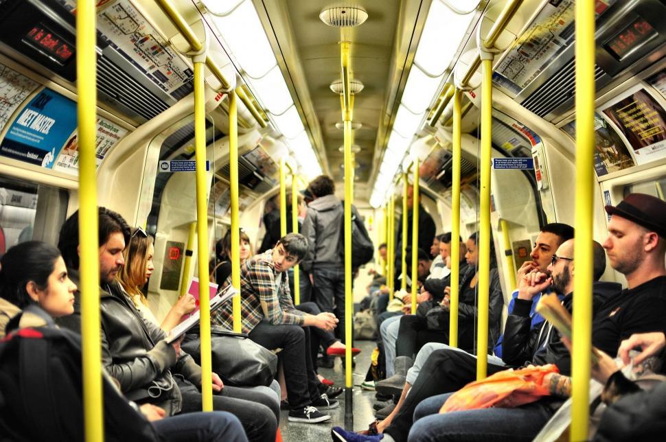 Free Image of Group of People Sitting on a Subway Train 